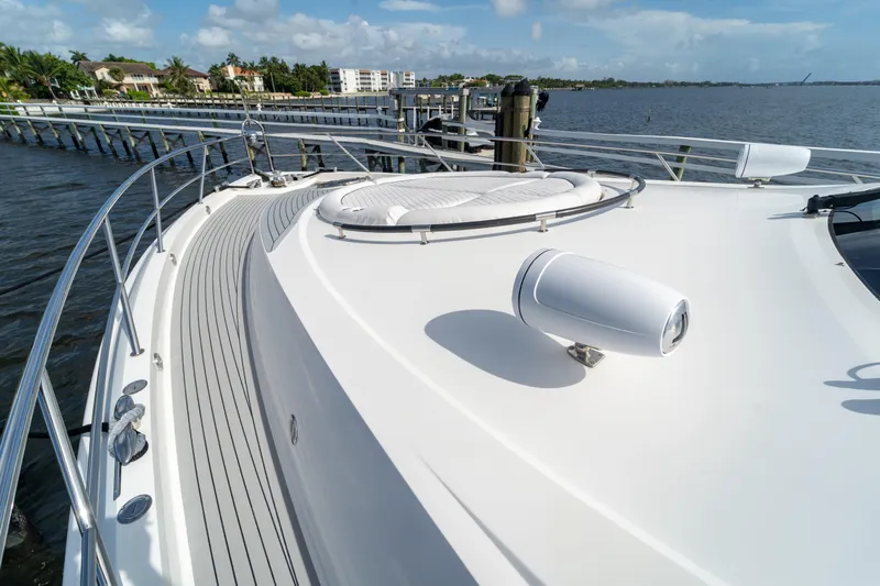 The Office Yacht Photos Pics 2009 Lazzara LSX 75 yacht deck with sleek design, docked by waterfront homes.