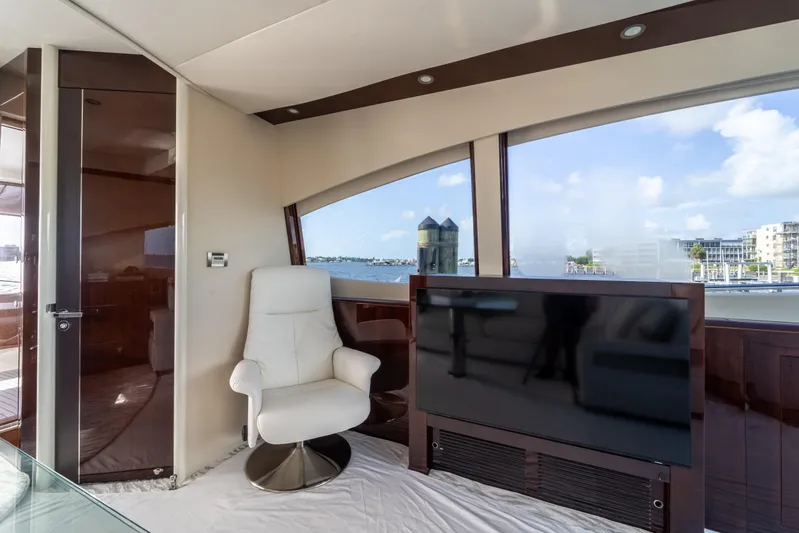 The Office Yacht Photos Pics Luxurious interior of 2009 Lazzara LSX 75 yacht with white chair and large TV.