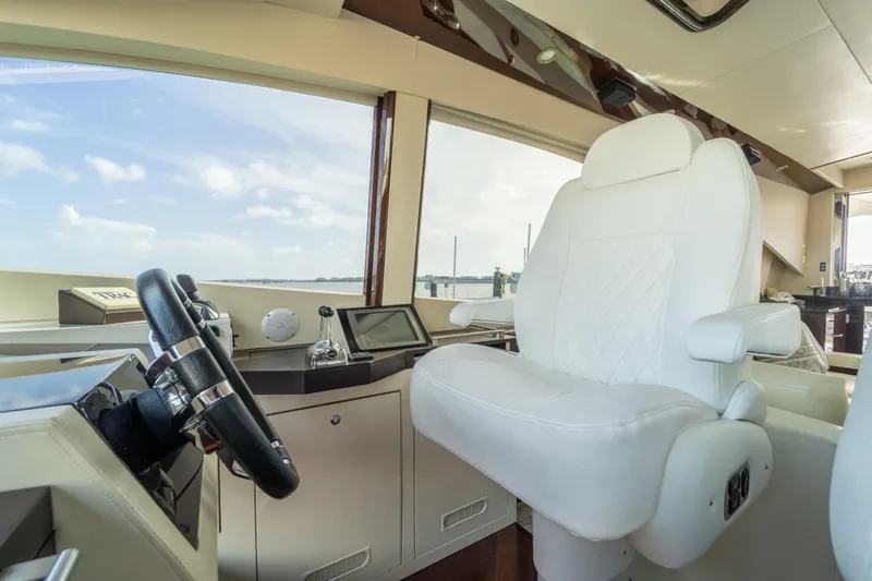 The Office Yacht Photos Pics Luxurious helm of 2009 Lazzara LSX 75 yacht with plush white captain's chair.