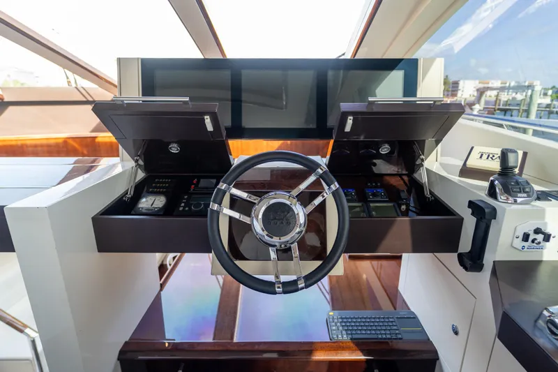 The Office Yacht Photos Pics 2009 Lazzara LSX 75 yacht helm with modern controls and sleek steering wheel.