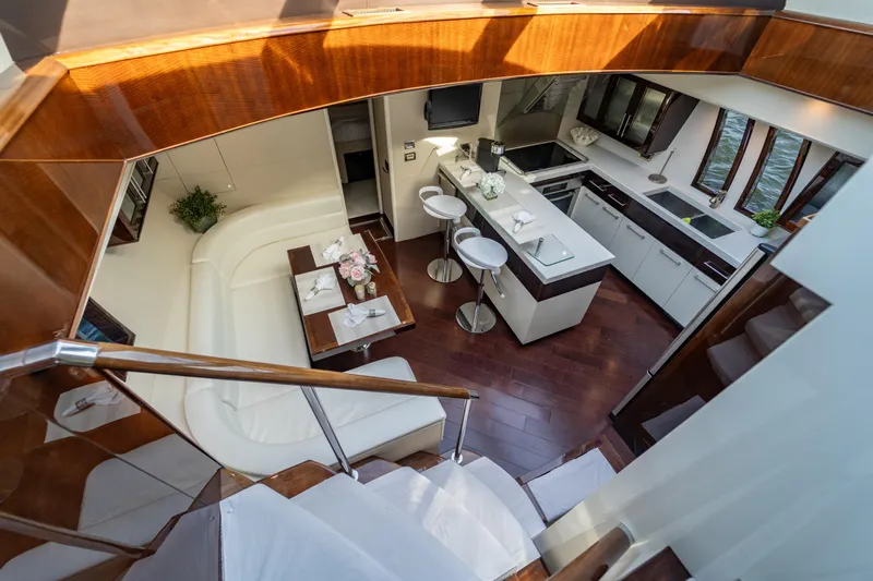 The Office Yacht Photos Pics Luxurious interior of 2009 Lazzara LSX 75 yacht with modern kitchen and seating area.