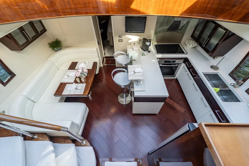 The Office Yacht Photos Pics Luxurious interior of 2009 Lazzara LSX 75 yacht with modern kitchen and seating area.