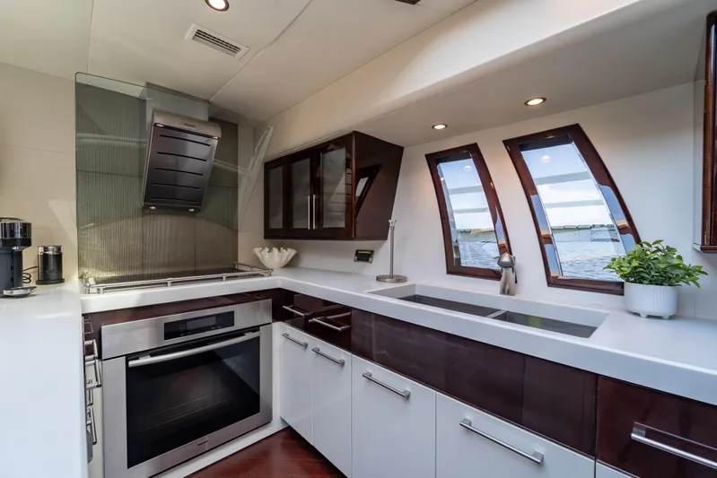 The Office Yacht Photos Pics Luxurious kitchen interior of 2009 Lazzara LSX 75 yacht with modern appliances and ocean view.