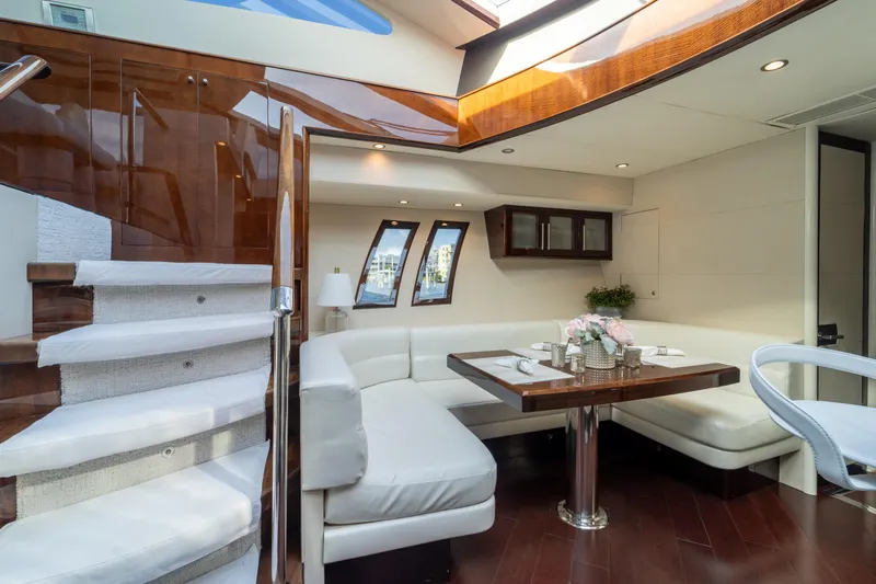 The Office Yacht Photos Pics Luxurious interior of 2009 Lazzara LSX 75 yacht with elegant dining area and staircase.