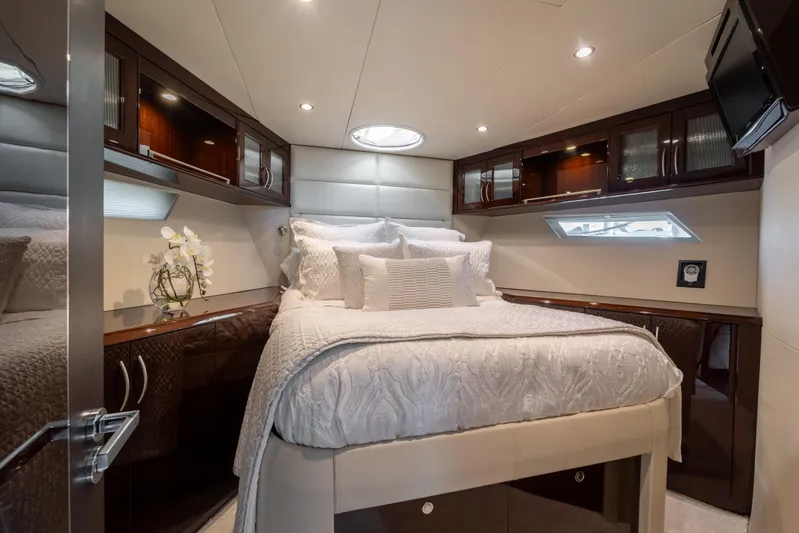 The Office Yacht Photos Pics Luxurious bedroom interior of 2009 Lazzara LSX 75 yacht with elegant bedding and wood cabinetry.