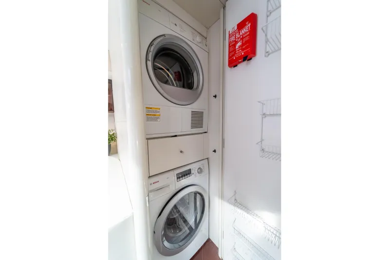 The Office Yacht Photos Pics Stacked washer and dryer in 2009 Lazzara LSX 75 yacht laundry area.