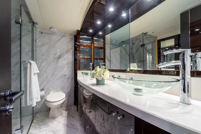 The Office Yacht Photos Pics Luxurious bathroom in 2009 Lazzara LSX 75 yacht with glass sink and marble decor.