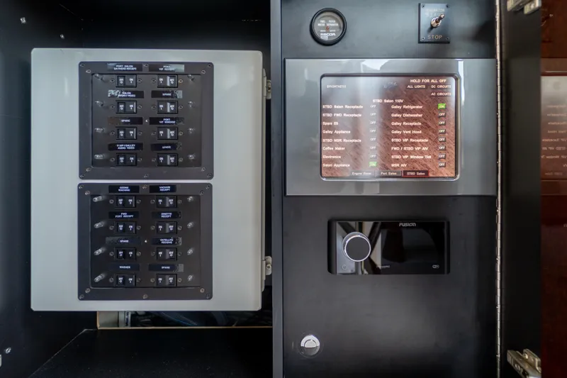 The Office Yacht Photos Pics Control panel of a 2009 Lazzara LSX 75 yacht, featuring switches and a digital display.