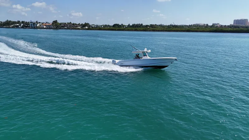  Yacht Photos Pics 2017 Boston Whaler 330 Outrage cruising on clear blue water.