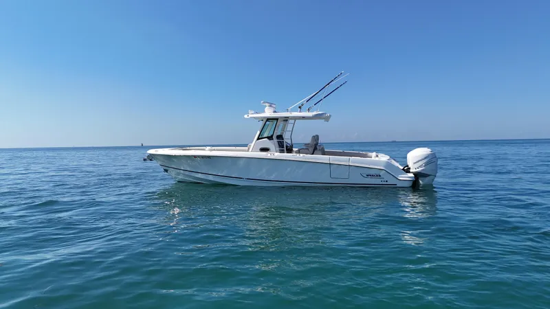  Yacht Photos Pics 2017 Boston Whaler 330 Outrage boat on calm ocean waters under clear blue sky.