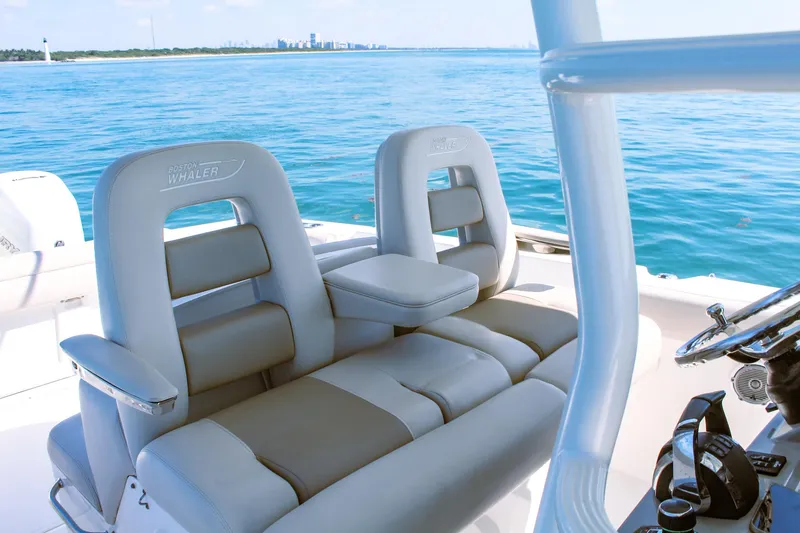  Yacht Photos Pics Boston Whaler 330 Outrage 2017 boat interior with luxurious seating on open water.