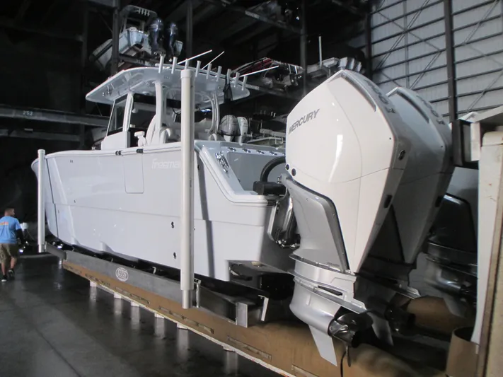  Yacht Photos Pics 2025 Freeman 38 boat with dual Mercury engines in a warehouse setting.