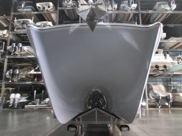  Yacht Photos Pics Front view of a 2025 Freeman 38 boat in storage, showcasing its sleek hull design.