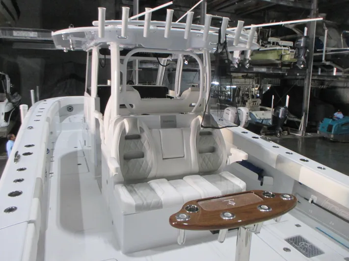 Yacht Photos Pics 2025 Freeman 38 boat interior with seating and rod holders in a showroom.