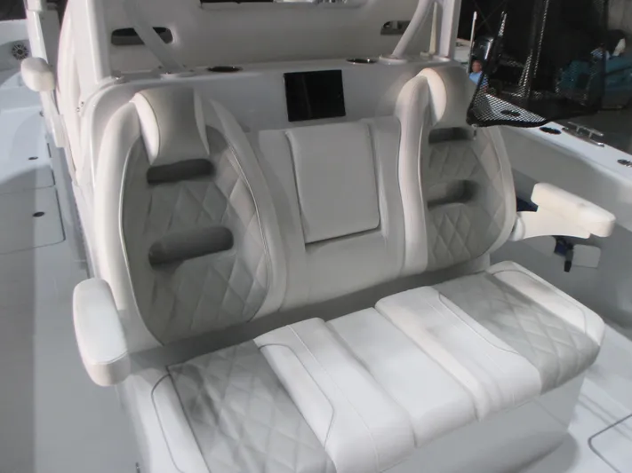  Yacht Photos Pics Luxurious seating on a 2025 Freeman 38 boat, featuring quilted upholstery and armrests.