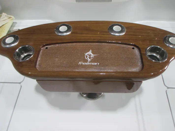  Yacht Photos Pics Freeman 38 boat console, 2025 model, featuring wood finish and cup holders.