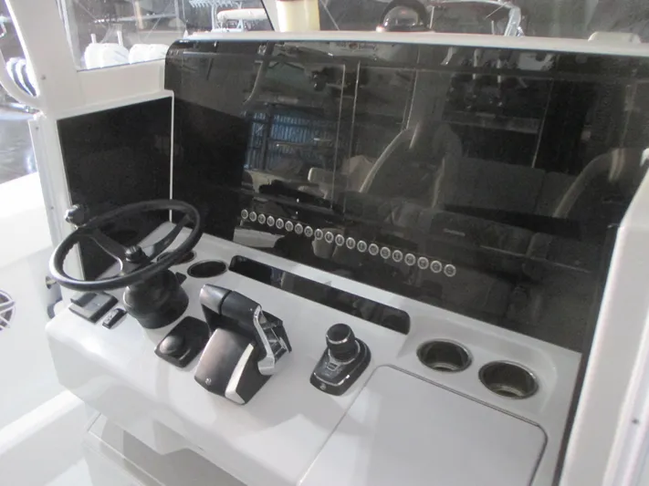  Yacht Photos Pics 2025 Freeman 38 boat dashboard with steering wheel and control panel.