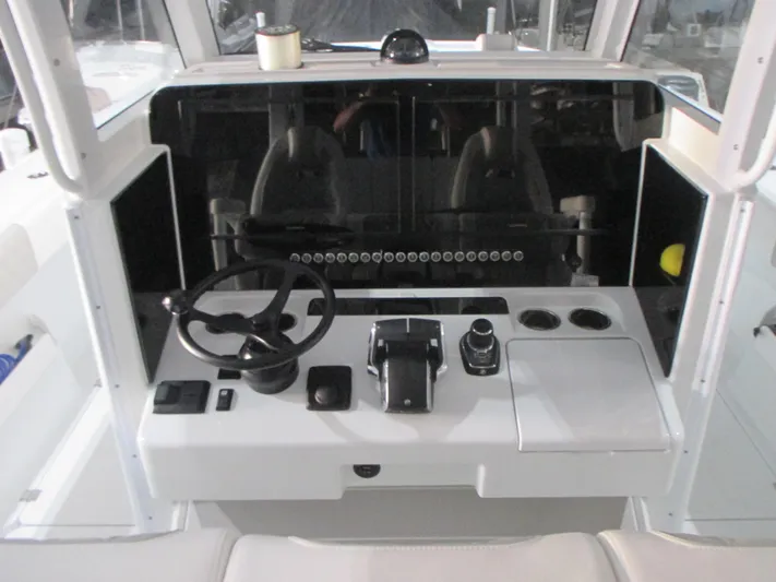  Yacht Photos Pics 2025 Freeman 38 boat cockpit with steering wheel, controls, and cup holders.