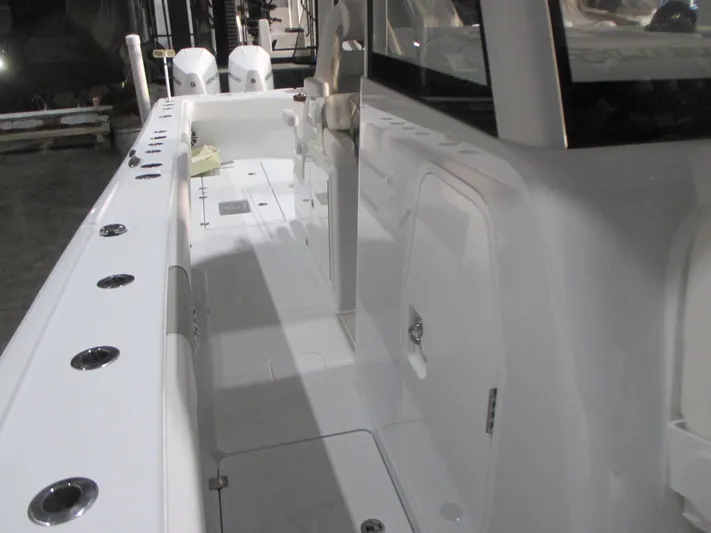  Yacht Photos Pics 2025 Freeman 38 boat interior with sleek white deck and storage compartments.
