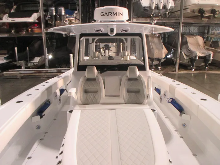  Yacht Photos Pics 2025 Freeman 38 boat interior with Garmin equipment, featuring white seating and spacious deck.