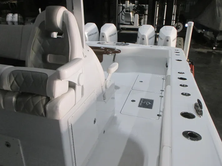  Yacht Photos Pics Luxurious interior of 2025 Freeman 38 boat with plush seating and multiple outboard engines.