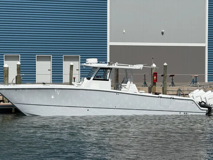  Yacht Photos Pics 2025 Freeman 38 boat docked by blue and gray building.