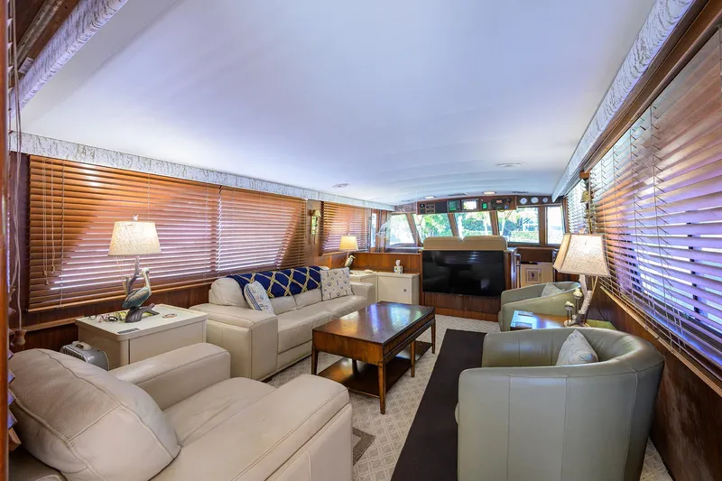 Phantom Yacht Photos Pics Luxurious interior of 1987 Hatteras 63 Motor Yacht with elegant seating and wooden blinds.