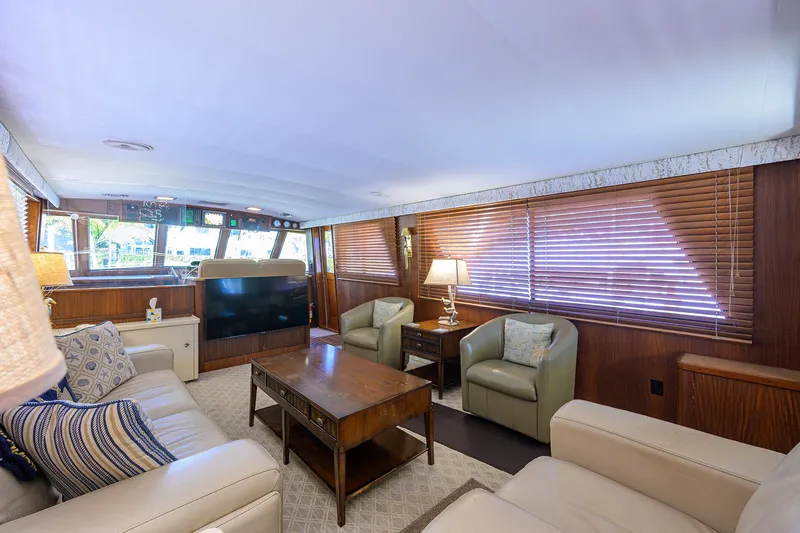 Phantom Yacht Photos Pics Luxurious interior of 1987 Hatteras 63 Motor Yacht with elegant seating and wooden accents.
