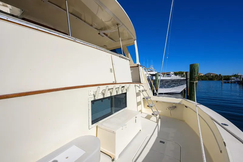 Phantom Yacht Photos Pics 1987 Hatteras 63 Motor Yacht deck with ladder, docked in sunny marina.