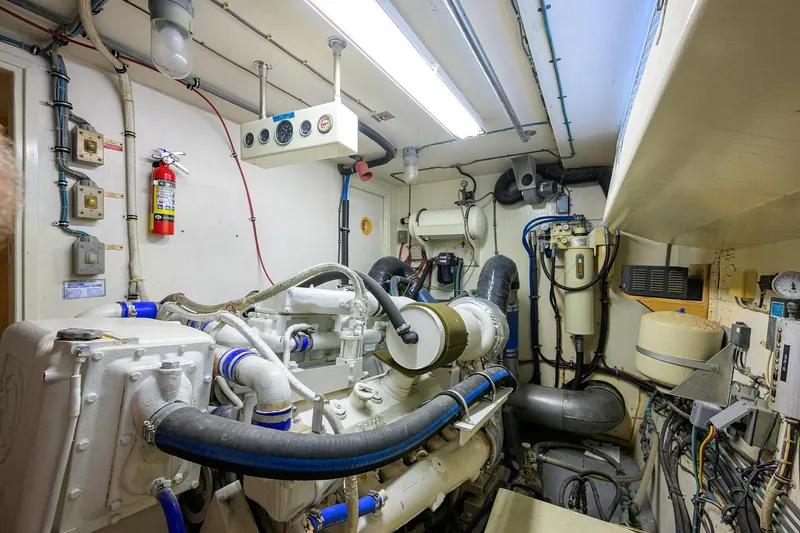 Phantom Yacht Photos Pics Engine room of a 1987 Hatteras 63 Motor Yacht, featuring complex machinery and equipment.
