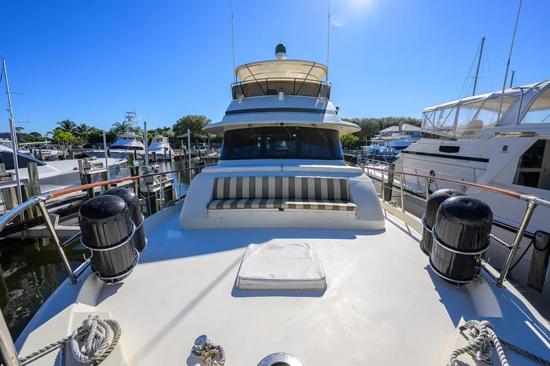 Phantom Yacht Photos Pics 1987 Hatteras 63 Motor Yacht docked at marina under clear blue sky.