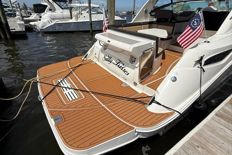  Yacht Photos Pics 2015 Sea Ray 350 Sundancer docked, featuring teak deck and American flags.