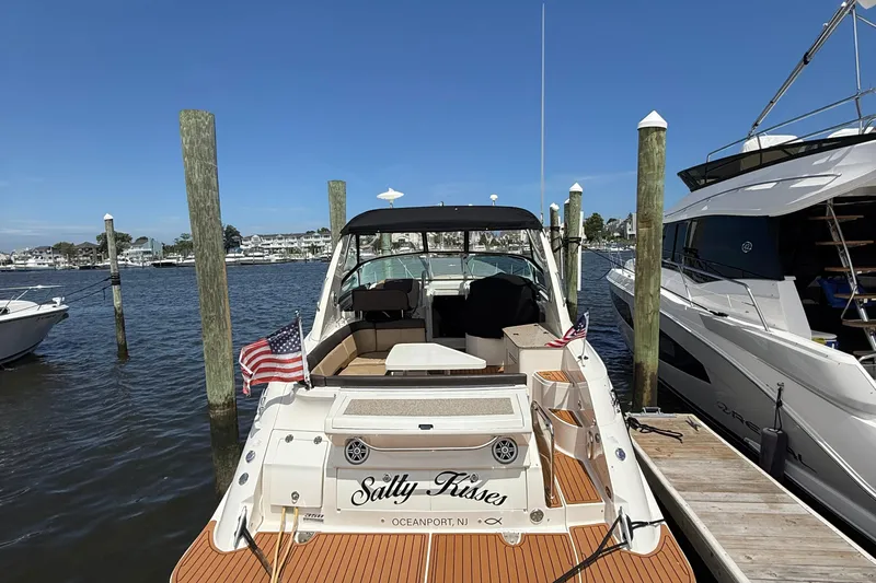  Yacht Photos Pics 2015 Sea Ray 350 Sundancer docked, featuring "Salty Kisses" name and American flags.