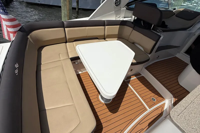  Yacht Photos Pics 2015 Sea Ray 350 Sundancer boat interior with cushioned seating and table.