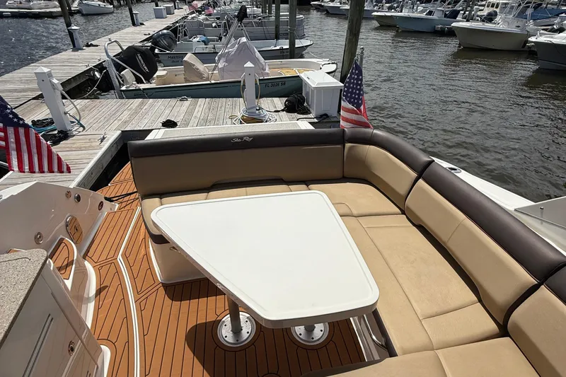  Yacht Photos Pics 2015 Sea Ray 350 Sundancer boat with seating area and table at marina dock.