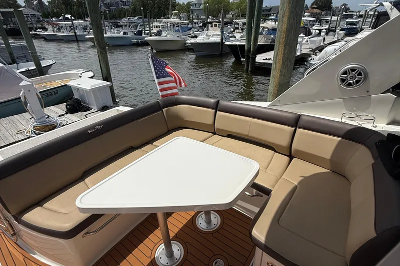 Yacht Photos Pics 2015 Sea Ray 350 Sundancer boat with seating area and table at marina.