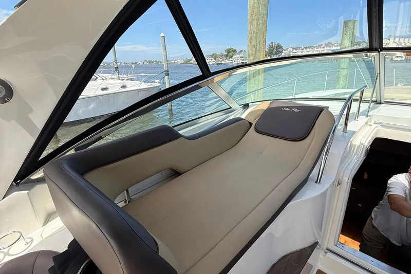  Yacht Photos Pics 2015 Sea Ray 350 Sundancer interior with beige seating, docked by the water.