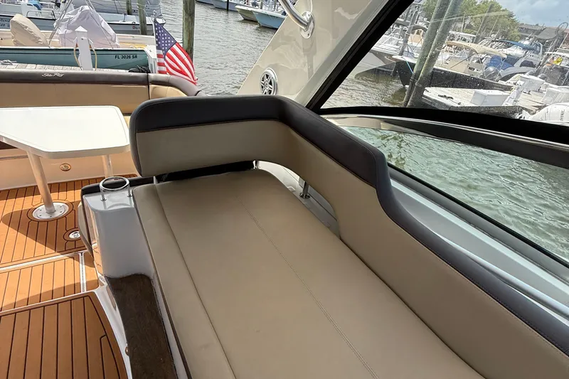  Yacht Photos Pics 2015 Sea Ray 350 Sundancer interior with seating and table, docked at marina.