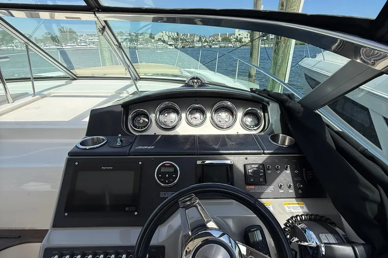  Yacht Photos Pics Cockpit view of 2015 Sea Ray 350 Sundancer with gauges and navigation equipment.