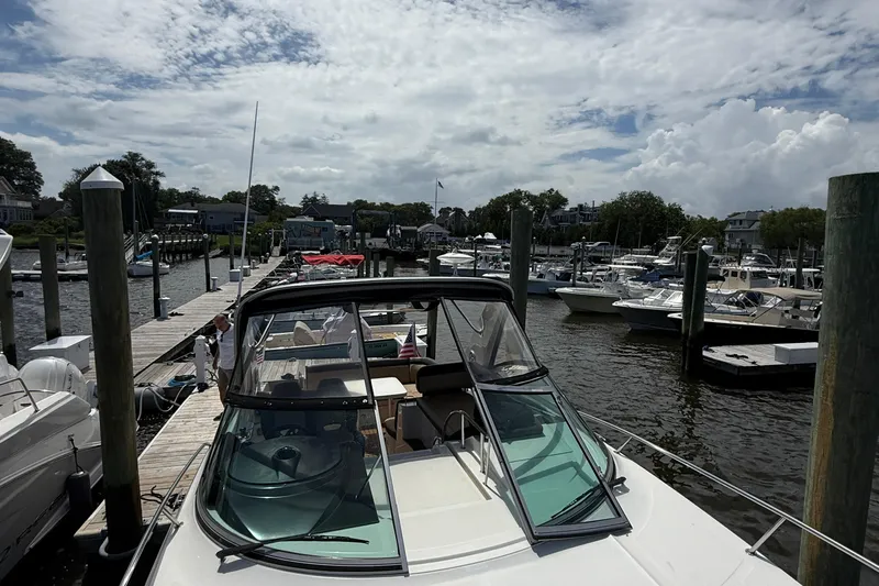  Yacht Photos Pics 2015 Sea Ray 350 Sundancer docked at a marina under a cloudy sky.