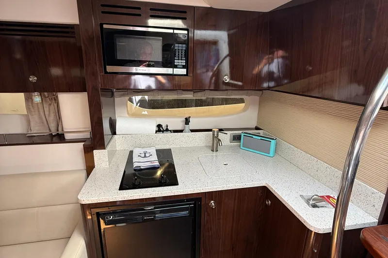  Yacht Photos Pics 2015 Sea Ray 350 Sundancer yacht kitchen with modern appliances and sleek design.