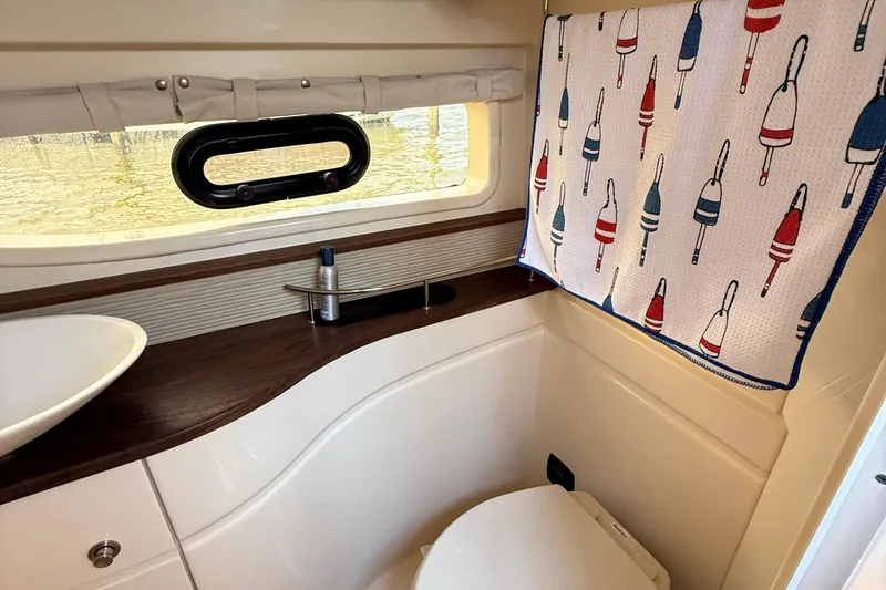  Yacht Photos Pics Bathroom interior of 2015 Sea Ray 350 Sundancer with nautical-themed decor.