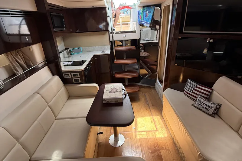  Yacht Photos Pics Luxurious interior of 2015 Sea Ray 350 Sundancer yacht with cozy seating and modern amenities.