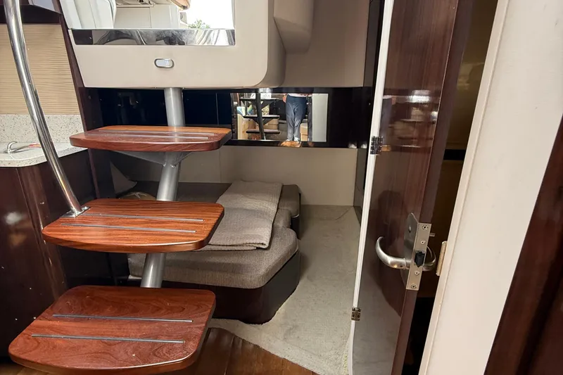  Yacht Photos Pics Interior of 2015 Sea Ray 350 Sundancer with wooden steps and cozy seating area.
