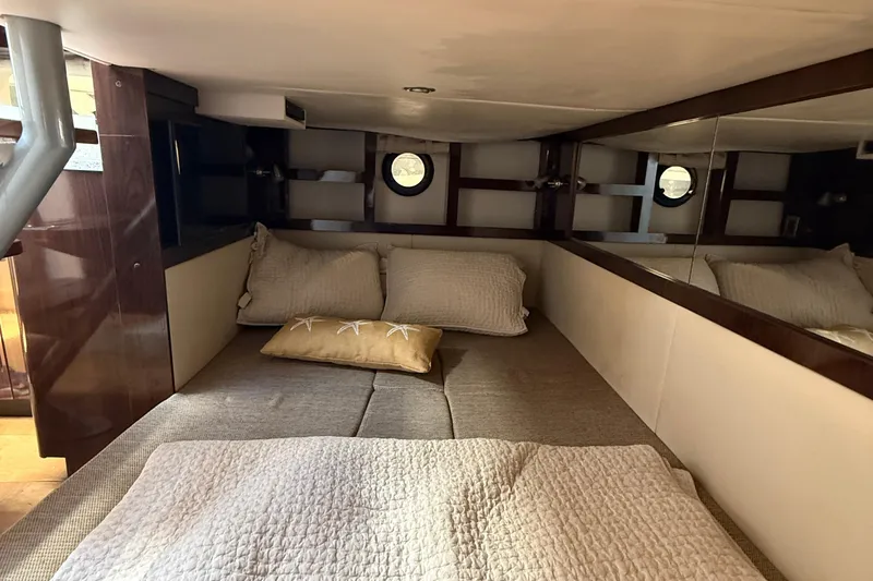  Yacht Photos Pics Cozy cabin interior of 2015 Sea Ray 350 Sundancer with bed and pillows.