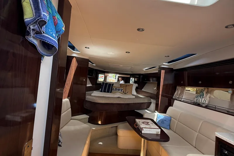  Yacht Photos Pics Luxurious interior of 2015 Sea Ray 350 Sundancer yacht with cozy seating and elegant decor.
