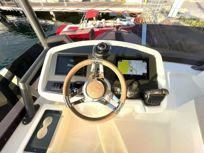 Rialtin Yacht Photos Pics Helm of 2022 Beneteau Monte Carlo 52 yacht with navigation screens and controls.