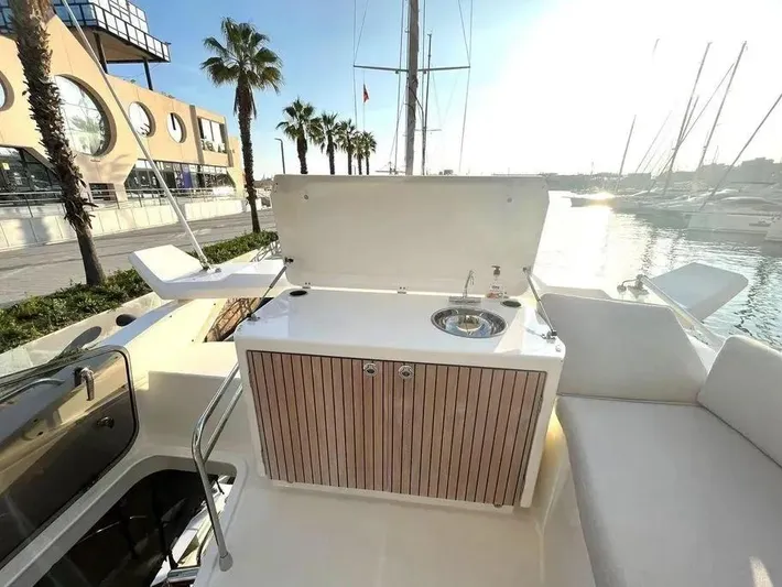 Rialtin Yacht Photos Pics Luxury outdoor kitchenette on 2022 Beneteau Monte Carlo 52 yacht, docked at marina.