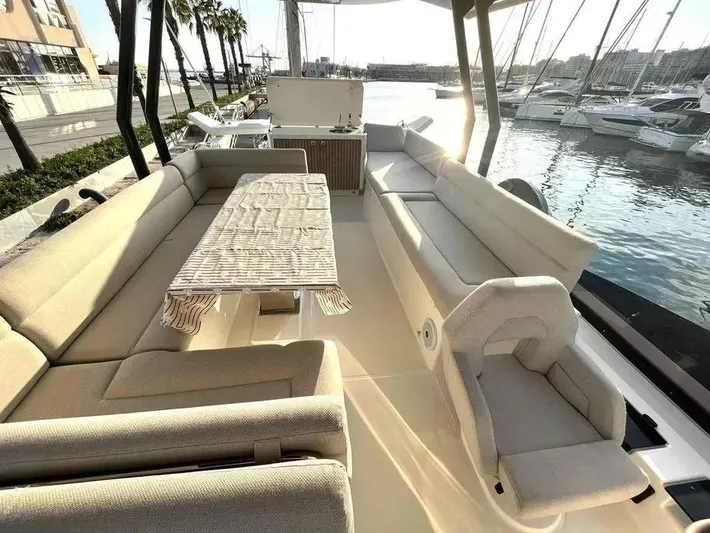 Rialtin Yacht Photos Pics Luxurious seating area on 2022 Beneteau Monte Carlo 52 yacht, docked at marina.