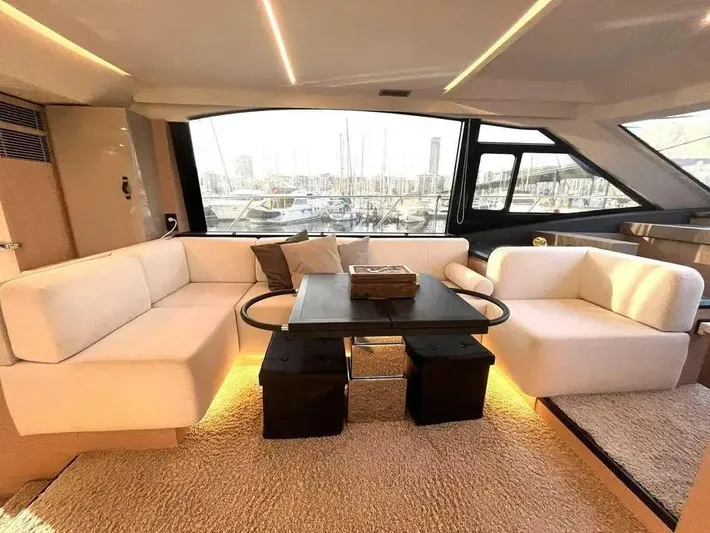 Rialtin Yacht Photos Pics Luxurious interior of 2022 Beneteau Monte Carlo 52 yacht with elegant seating and marina view.